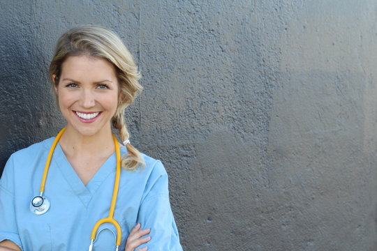 Beautiful young doctor with stethoscope and copy space for text 