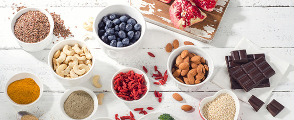 Super foods on a white wooden board.