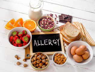 Food allergy. Allergic food on  wooden background. - obrazy, fototapety, plakaty