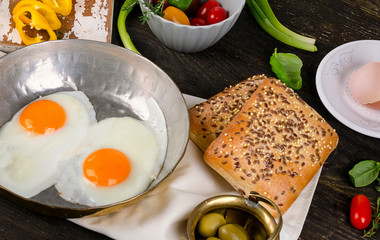 Fried eggs on a rustic wooden table