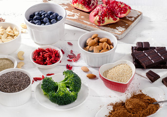 Super foods on white wooden board.