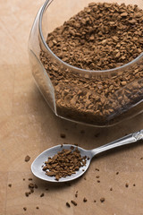 Spoon of coffee on wooden table