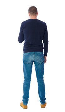 Back view of man in jeans. Standing young guy. Rear view people collection.  backside view of person.  Isolated over white background.  A guy in a black sweater standing and looking at the phone.