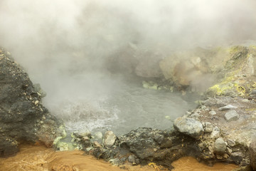 Seething cauldron of boiling water in crater Mutnovsky volcano.