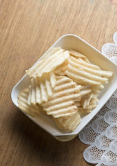 potato chips on wooden plate