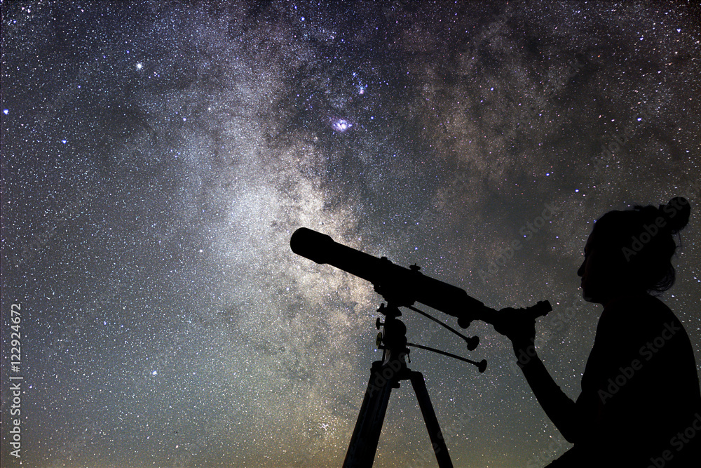 Wall mural woman and night sky. watching the stars woman with telescope.