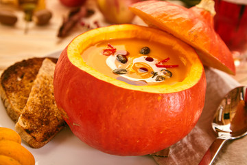 Close up of squash soup in hollowed out gourd