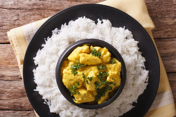 Indian Cuisine: Korma chicken in coconut sauce and basmati rice. horizontal top view
