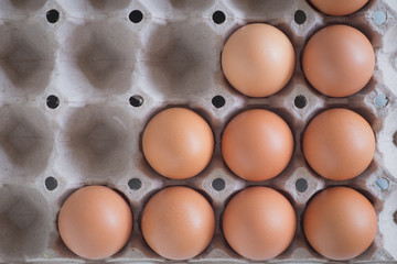 Egg in a wooden bowl on wooden table white. Chicken Egg. Top view with copy space