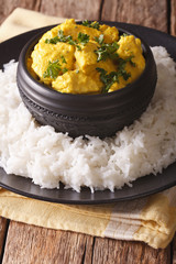 Indian chicken Korma with basmati rice close-up. vertical
