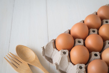 Egg in a wooden bowl on wooden table white. Chicken Egg. Top view with copy space