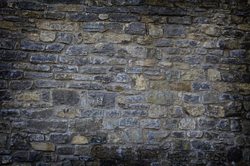 old stone wall using multi colored stones