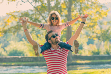 Father and daughter enjoying in the park.