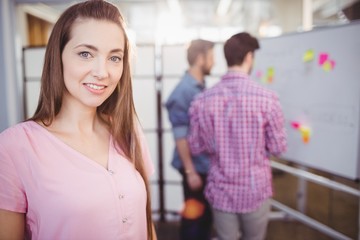 Portrait of beautiful executive standing creative office