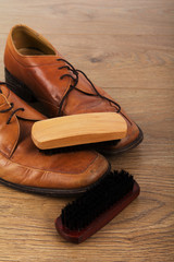 Shoes and cleaning equipment on a wooden floor