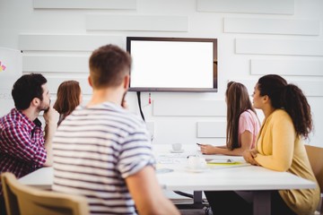 Executives watching at television during training 