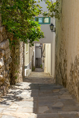 Fototapeta na wymiar Traditional narrow street in Chora town, Naxos Island, Cyclades,