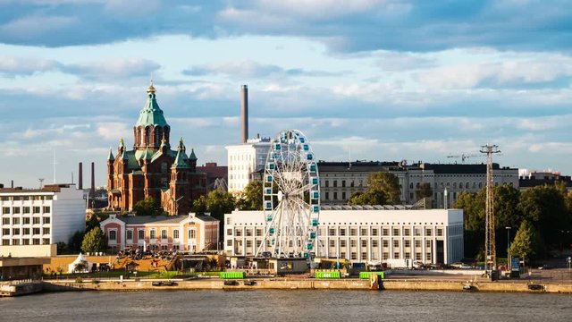 Helsinki, Finland port with historic buildings and Ferry Wheel .Fast pacing clouds. Time-lapse in the evening