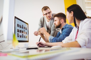 Executive assisting colleagues at creative office