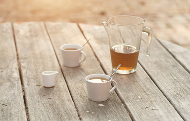 Vintage photo of a tea cups on wooden table