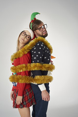 Couple wrapped in golden Christmas chain.