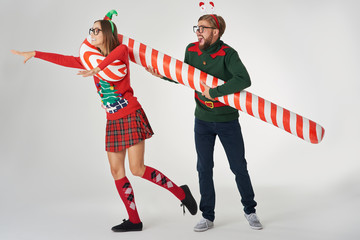Man catching his girlfriend with a candy cane - obrazy, fototapety, plakaty