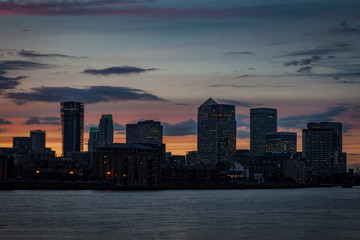 Fototapeta na wymiar Silhouette of Canary Wharf at sunset a major business district in Tower Hamlets, East London. It is one of the United Kingdom's main financial centre and contains many of Europe's tallest buildings