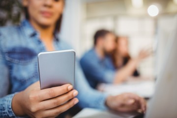 Businesswoman using mobile phone