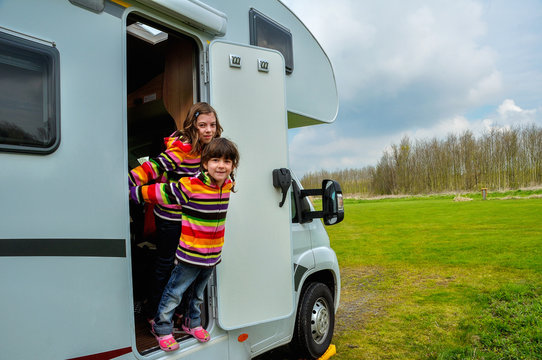 Kids in camper (rv), family travel in motorhome on vacation
