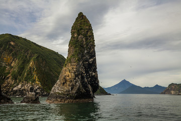 Fototapeta na wymiar Scenic high rocks in the Pacific Ocean. Kamchatka Peninsula.