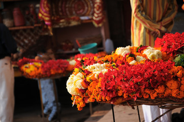 Religious flower shop beside bank of Ganges river, Varanasi, India.