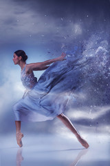 Fototapeta premium The beautiful ballerina dancing in blue long dress 