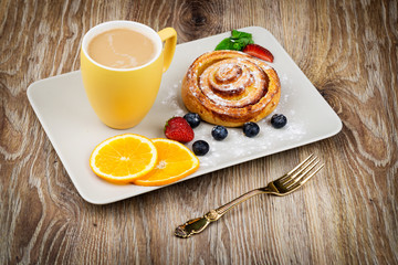 Cup of coffee and pastry on wooden background