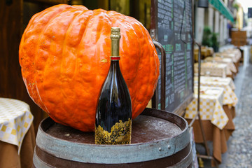 Italian restaurant with pumpkin and champagne on a wine barrel