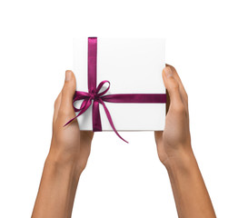 Isolated Woman Hands holding Holiday Present White Box with Pink Ribbon on a White Background