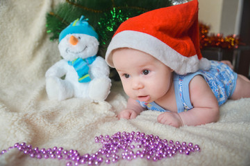 Obraz na płótnie Canvas Christmas card with cute baby boy weared in santa red hat