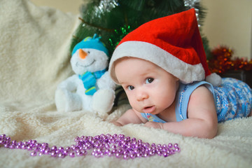 Christmas card with cute baby boy weared in santa red hat