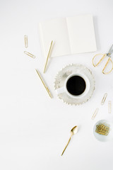 coffee cup, empty diary and golden accessories: tea spoon, pen, clips and scissors on white background. flat lay, top view