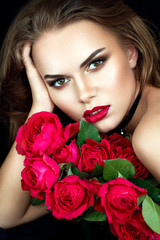 Beautiful woman portrait with flowers. Gorgeous make up and red lipstick.
