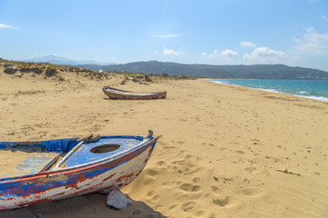 Fototapeta na wymiar Abandoned fishing boat on one of the most beautiful beaches in t