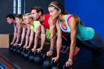 Athletes exercising with kettlebells