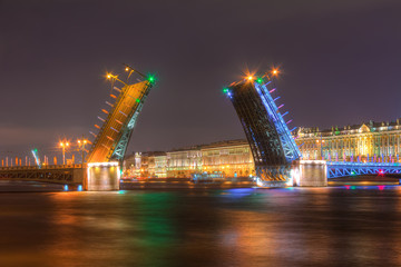Fototapeta na wymiar Night view of illuminated Neva River, open Palace Bridge and Palace Embankment, Saint Petersburg, Russia.