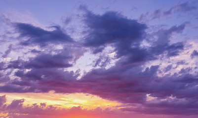 Fototapeta premium Beautiful sunset through the evening cloudy sky/Beautiful sunset through the evening cloudy sky