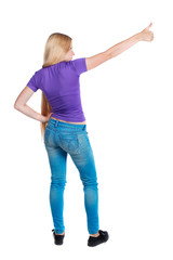 Back view of  pointing woman. beautiful girl. Rear view people collection.  backside view of person.  Isolated over white background. Long-haired blonde in the purple shirt is pointing sideways.