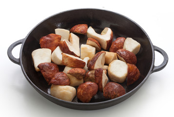 White mushrooms in the black iron pan