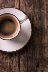 coffee cup and coffee beans on vintage wooden background