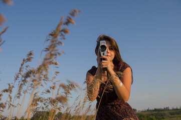 Girl shoots a movie camera