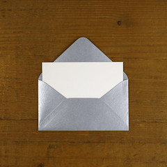 open silver envelope on wooden background
