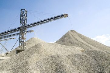 Working belt conveyors and a piles of rubble in Gravel Quarry