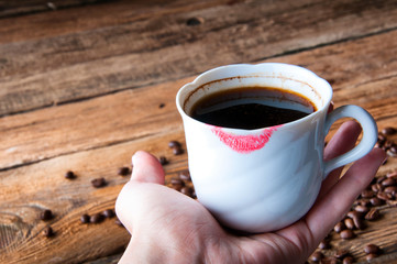 Red lipstick on a cup of coffee. Copyspace
